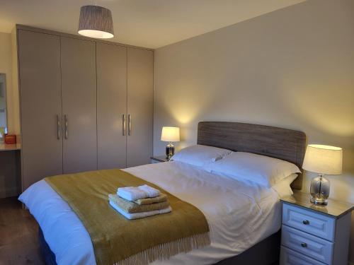 a bedroom with a bed with two towels on it at Village View in Adare