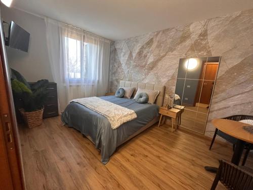 a bedroom with a bed with blue pillows on it at Elite in Rovigo