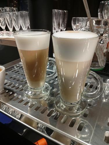 two glasses sitting on top of a metal table at Hôtel de l'abbaye in Saint-Savin