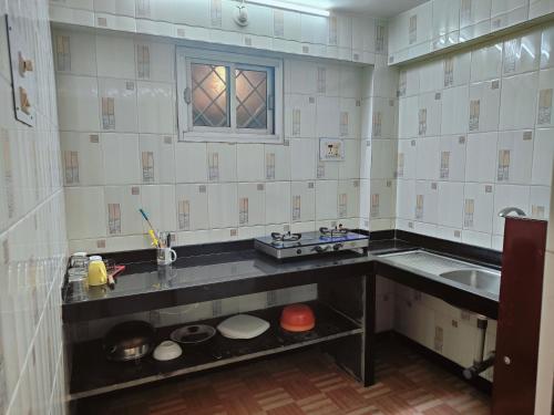 a kitchen with a counter and a sink at Little Nest in Mandrem