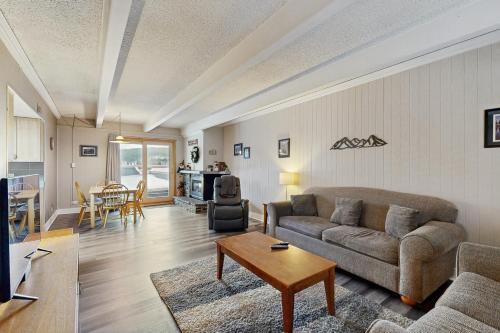 a living room with a couch and a table at Ski and Racquet Club Condo in Breckenridge