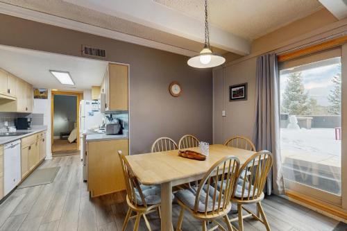 a kitchen and dining room with a table and chairs at Ski and Racquet Club Condo in Breckenridge