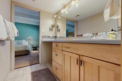 a bathroom with a sink and a large mirror at Ski and Racquet Club Condo in Breckenridge