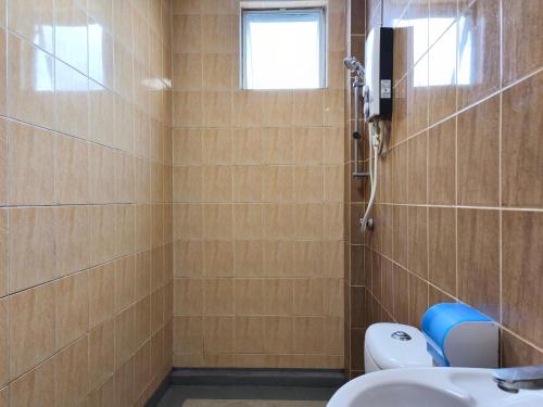 a bathroom with a shower and a toilet and a sink at Eden 8pax 3Rooms apartment near Kuching Airport in Kuching