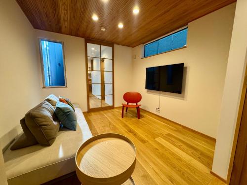 a living room with a couch and a table at Villa Monica Premium in Nagoya