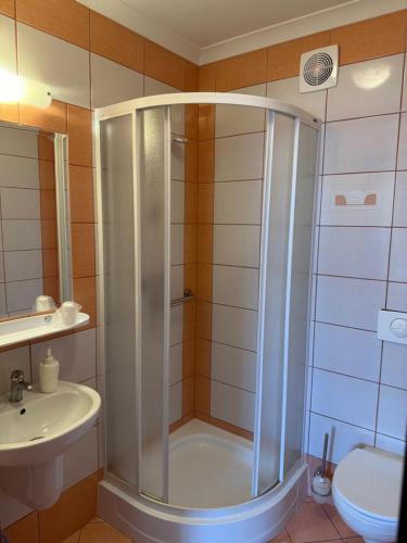 a bathroom with a shower and a sink at Hotel Aleksander in Ustka
