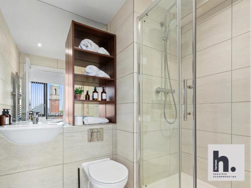 a bathroom with a shower and a toilet and a sink at Contractors - Free Parking - City Centre - Balcony - x21 in Hull