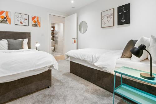 a bedroom with two beds and a blue table at Contractors - Free Parking - City Centre - Balcony - x21 in Hull