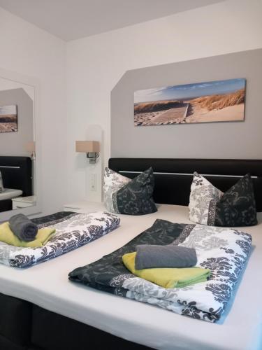 two beds with pillows sitting on top of a table at Westend-Palais in Ahlbeck