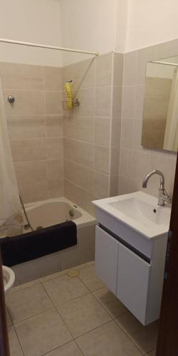 a bathroom with a sink and a tub and a toilet at sitbonim in Netanya