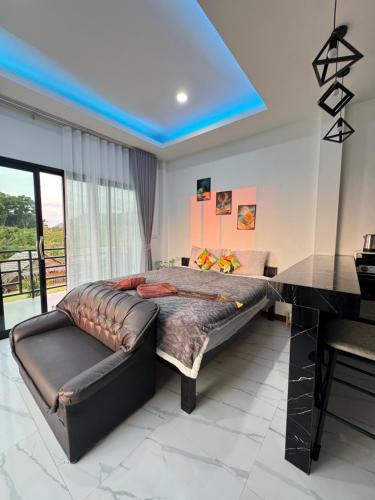 a bedroom with a large bed and a desk at Seaview phuwamin in Ko Lanta