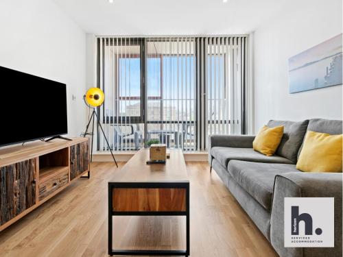 a living room with a couch and a tv at Contractor Stays - 6 Units - City Centre - Siemens - NHS - Uni - Free Parking - Balcony in Hull