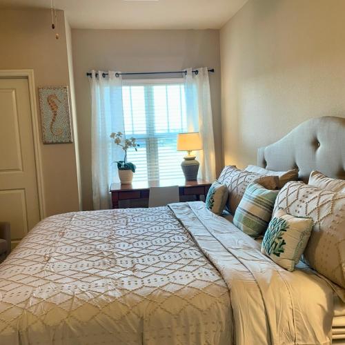 a bedroom with a large bed and a window at Coastal Comfort in Jacksonville