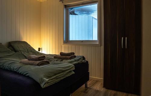 a bedroom with a bed with towels on it at Apartment in Senja in Senja