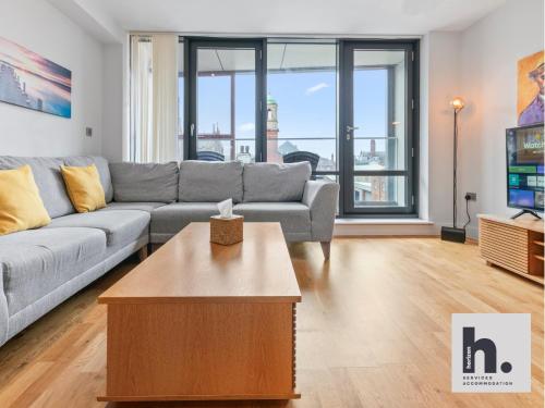 a living room with a couch and a table at Contractor Stays - 6 Units - City Centre - Siemens - NHS - Uni - Free Parking - Balcony in Hull