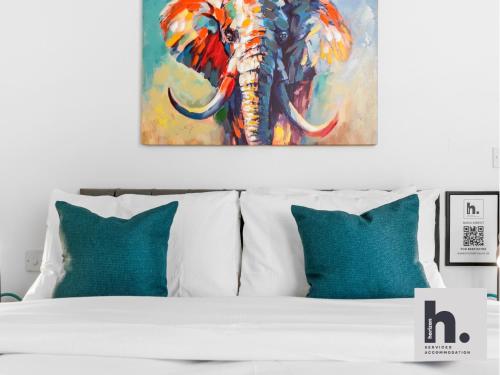 a bedroom with a bed with a painting of an elephant at Contractor Stays - 3 Units - City Centre - Siemens - NHS - Uni - Free Parking in Hull