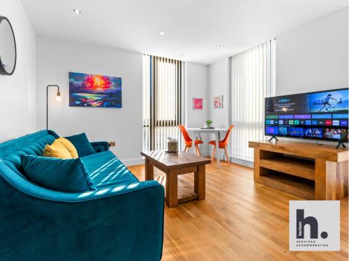 a living room with a blue couch and a table at Contractor Stays - 3 Units - City Centre - Siemens - NHS - Uni - Free Parking in Hull