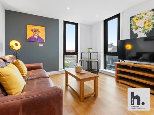 a living room with a couch and a flat screen tv at Contractor Stays - 3 Units - City Centre - Siemens - NHS - Uni - Free Parking in Hull