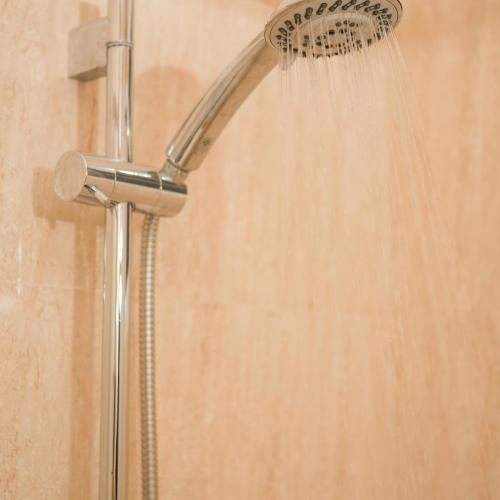 a shower with a shower head in a bathroom at Casa De Coral Boutique Hotel in Kata Beach