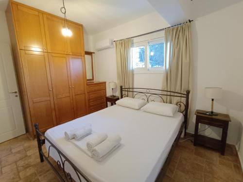 a bedroom with a bed with two towels on it at Aura di Mare in Barbati