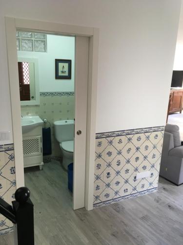 a bathroom with a toilet and a tub and a sink at Maresia in Sines