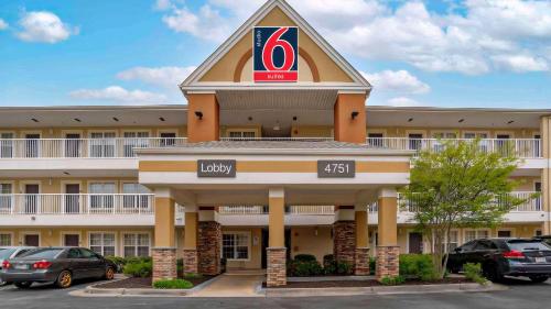 a hotel with a hotel sign on the front of it at Studio 6 Extended Stay Huntsville, AL - US Space & Rocket Center in Huntsville