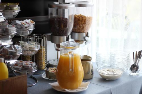a table with some juice and other food items at Pension Alpentraum in Zell am See