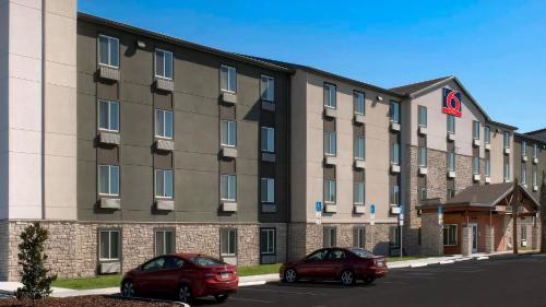 two cars parked in front of a building at Studio 6 Extended Stay Bossier City, LA - Shreveport in Bossier City