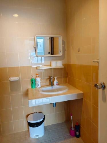 a bathroom with a sink and a mirror at Banana Bunkhouse Hostel in Rawai Beach