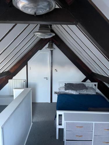 a attic room with a bed and a ceiling at Seaview Terrace in Skerries