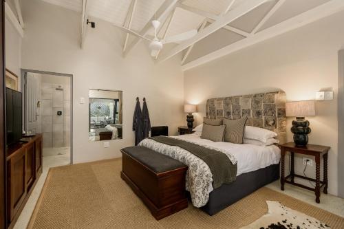a bedroom with a large bed and a bathroom at Inverell Station by The Oyster Collection in Kenton on Sea