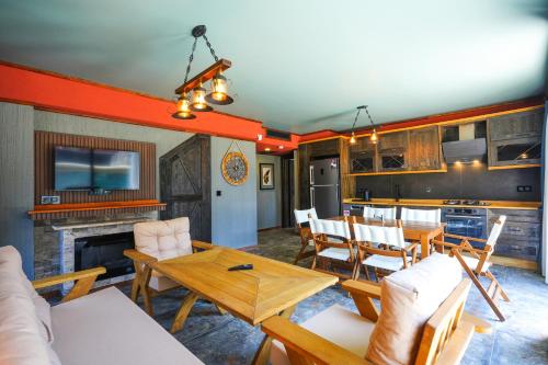 a living room with a table and chairs and a kitchen at champion villas in Ortaca