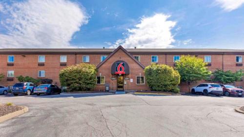 a large brick building with a delta sign on it at Studio 6 Extended Stay - St Louis, MO - Westport Craig Road in Maryland Heights