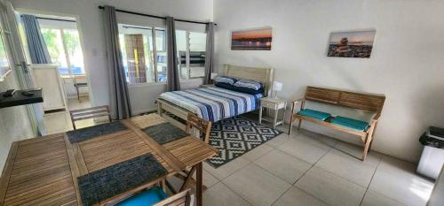 a room with two beds and a table and benches at HAPPY JUNGLE at 6 in St Lucia