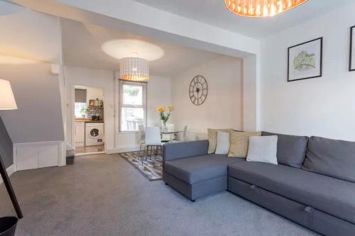a living room with a couch and a table at Hastings House - Modern 2 Bedroom House in Central Luton & Near Airport in Luton