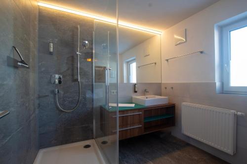 a bathroom with a shower and a sink at Panorama Apartments - Steinbock Lodges in Zell am See