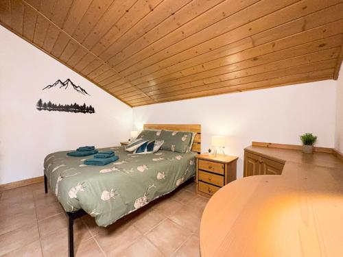 a bedroom with a bed and a wooden ceiling at Begar Nest - ski slope front and panoramic in Sappada