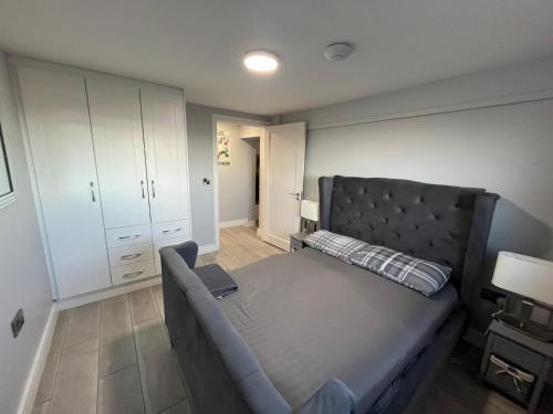 a bedroom with a large bed and a couch at The Captains Wheel in Skerries