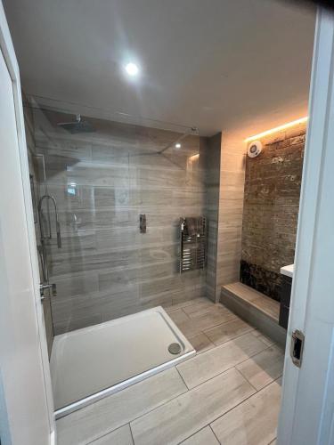 a bathroom with a shower with a bath tub at The Captains Wheel in Skerries