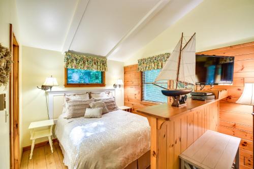 a bedroom with a bed with a sailboat on it at 'Pine Cottage' Duplex w/ Deck: Walk to State Park! in Ephraim