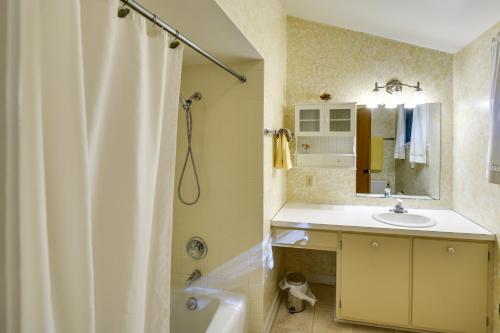 a bathroom with a white shower curtain and a sink at 'Pine Cottage' Duplex w/ Deck: Walk to State Park! in Ephraim