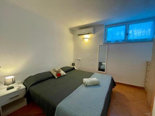 a small bedroom with two beds and a window at Bungalow Punta in Umag