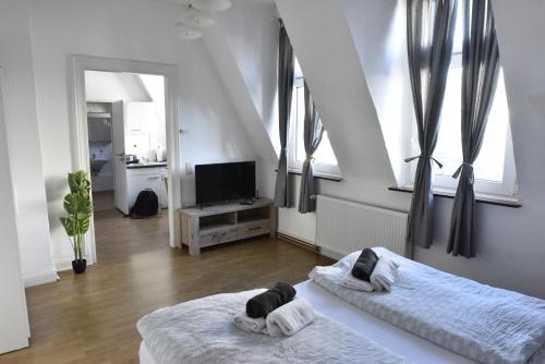 a bedroom with two beds and a television in it at Fewo Wuppertal in Wuppertal