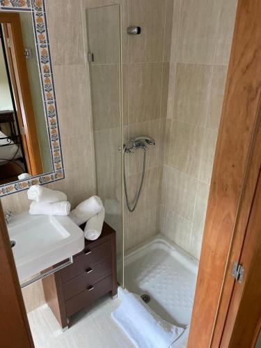 a bathroom with a shower and a sink at Quinta do Ferrador in Viana do Castelo