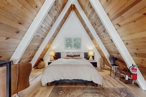 a bedroom with a large bed in a room with wooden ceilings at Elati Escape in South Lake Tahoe