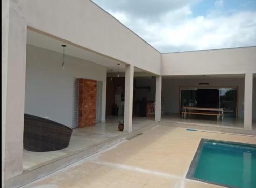 a large room with a swimming pool in a house at Sitio Vila Monte Verde in Jaboticatubas
