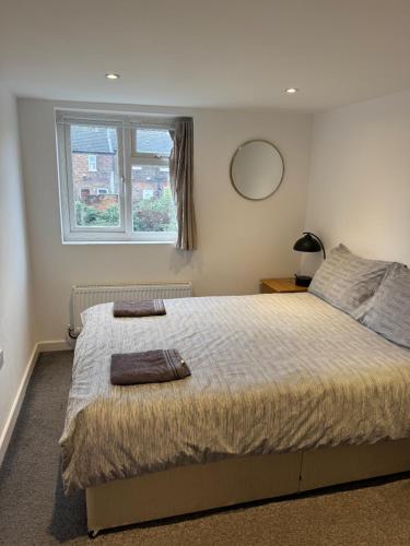 a bedroom with a large bed and a window at Luton Town Homestay - Near AIRPORT & Train Station, High Speed Internet in Luton