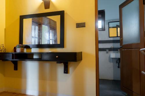 a bathroom with a sink and a mirror on a wall at Rose Villa by Kananke Hills in Kananke