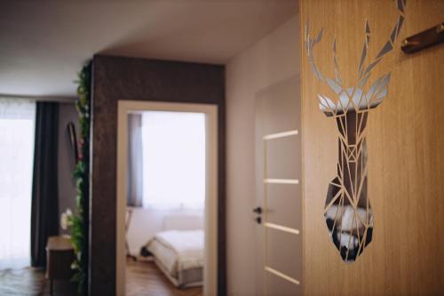 a room with a door with a deer head on it at Apartament Panorama Boho in Mława