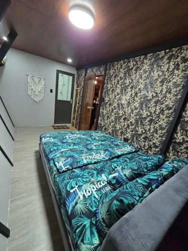 a bedroom with a large bed in a room at Tasha's Place in Antipolo